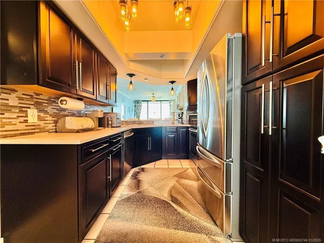 a kitchen with stainless steel appliances granite countertop a stove a refrigerator and a microwave