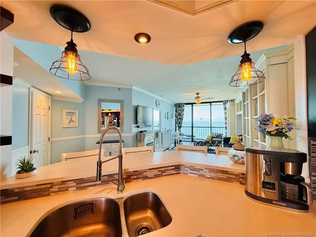 a kitchen with a sink and a refrigerator