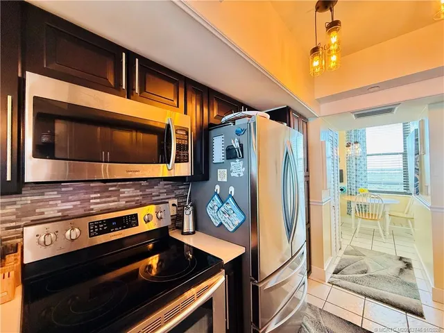 a living room with a couch and a bookshelf with wooden floor