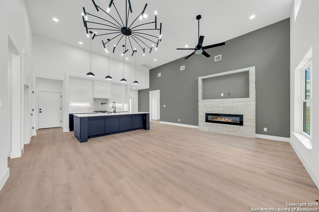 661 Jonquil Drive Spring Branch, TX 78070 - Photo 7 of 18 a view of an empty room with a window and a kitchen