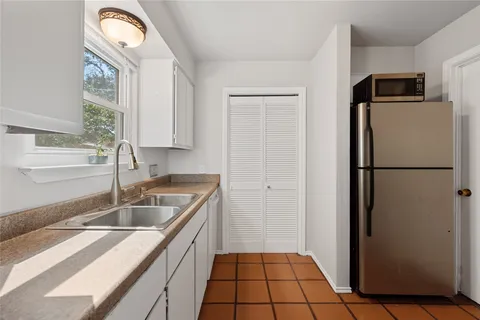 a kitchen with a refrigerator and cabinets
