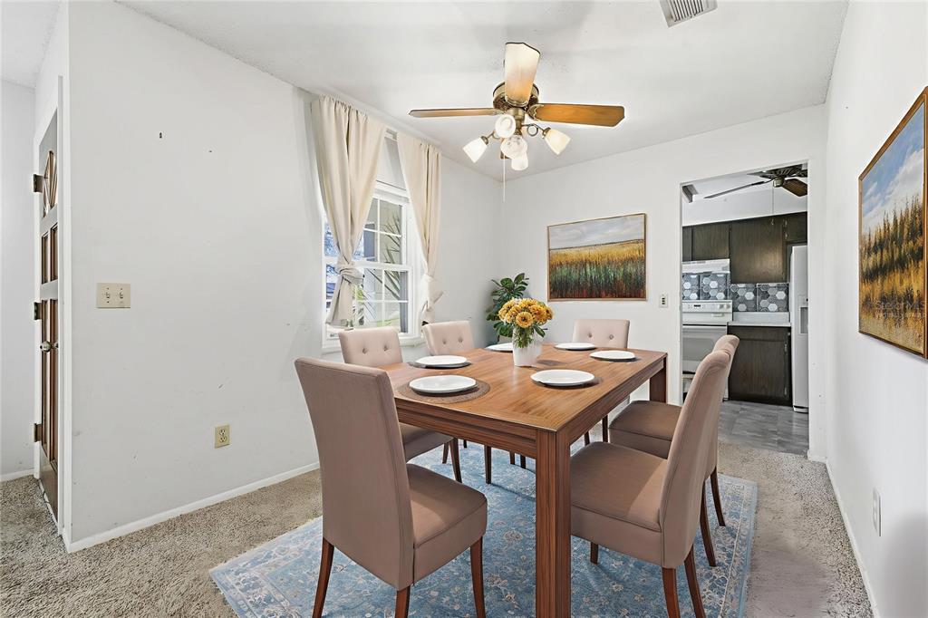 520 Jupiter Way Casselberry, FL 32707 - Photo 11 of 49 a view of a dining room with furniture and a chandelier fan