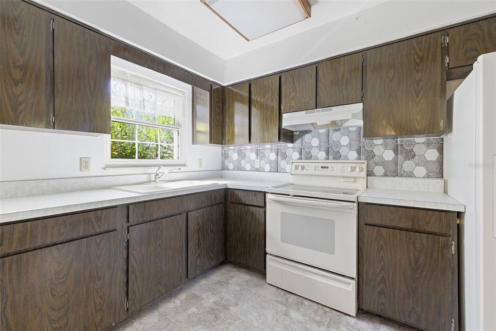 520 Jupiter Way Casselberry, FL 32707 - Photo 18 of 49 a kitchen with a sink stove and cabinets