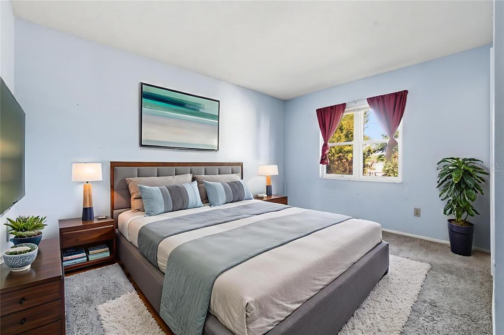 520 Jupiter Way Casselberry, FL 32707 - Photo 22 of 49 a bedroom with bed and paintings on the wall