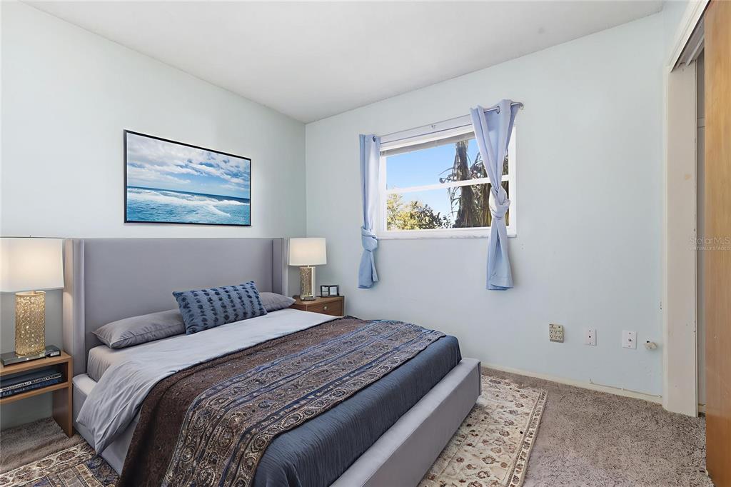 520 Jupiter Way Casselberry, FL 32707 - Photo 28 of 49 a bedroom with a bed and a painting on the wall