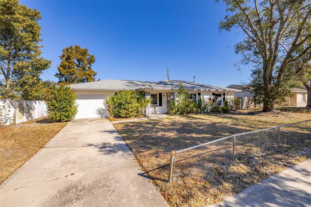 520 Jupiter Way Casselberry, FL 32707 - Photo 4 of 49 a front view of a house with a yard and a garage