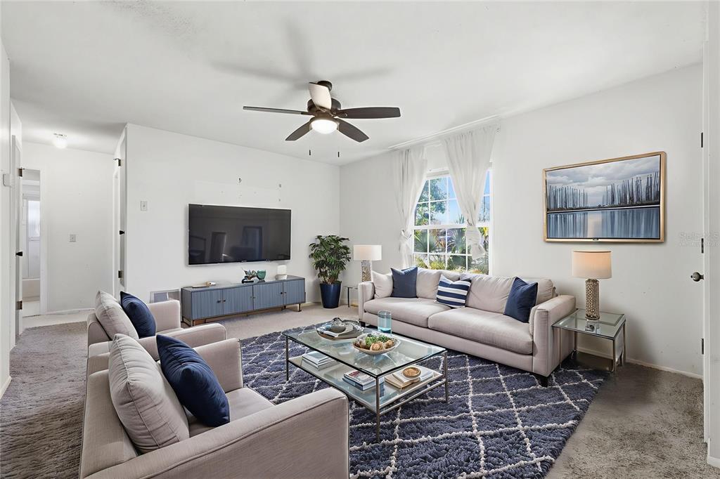520 Jupiter Way Casselberry, FL 32707 - Photo 9 of 49 a living room with furniture a flat screen tv and a window