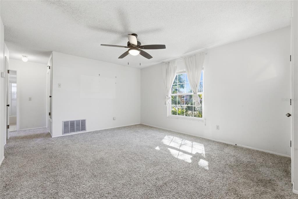 520 Jupiter Way Casselberry, FL 32707 - Photo 10 of 49 an empty room with windows and fan