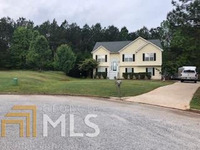 315 Bellevue Ridge Locust Grove, GA 30248 - Photo 1 of 1 a front view of a house with a yard and trees