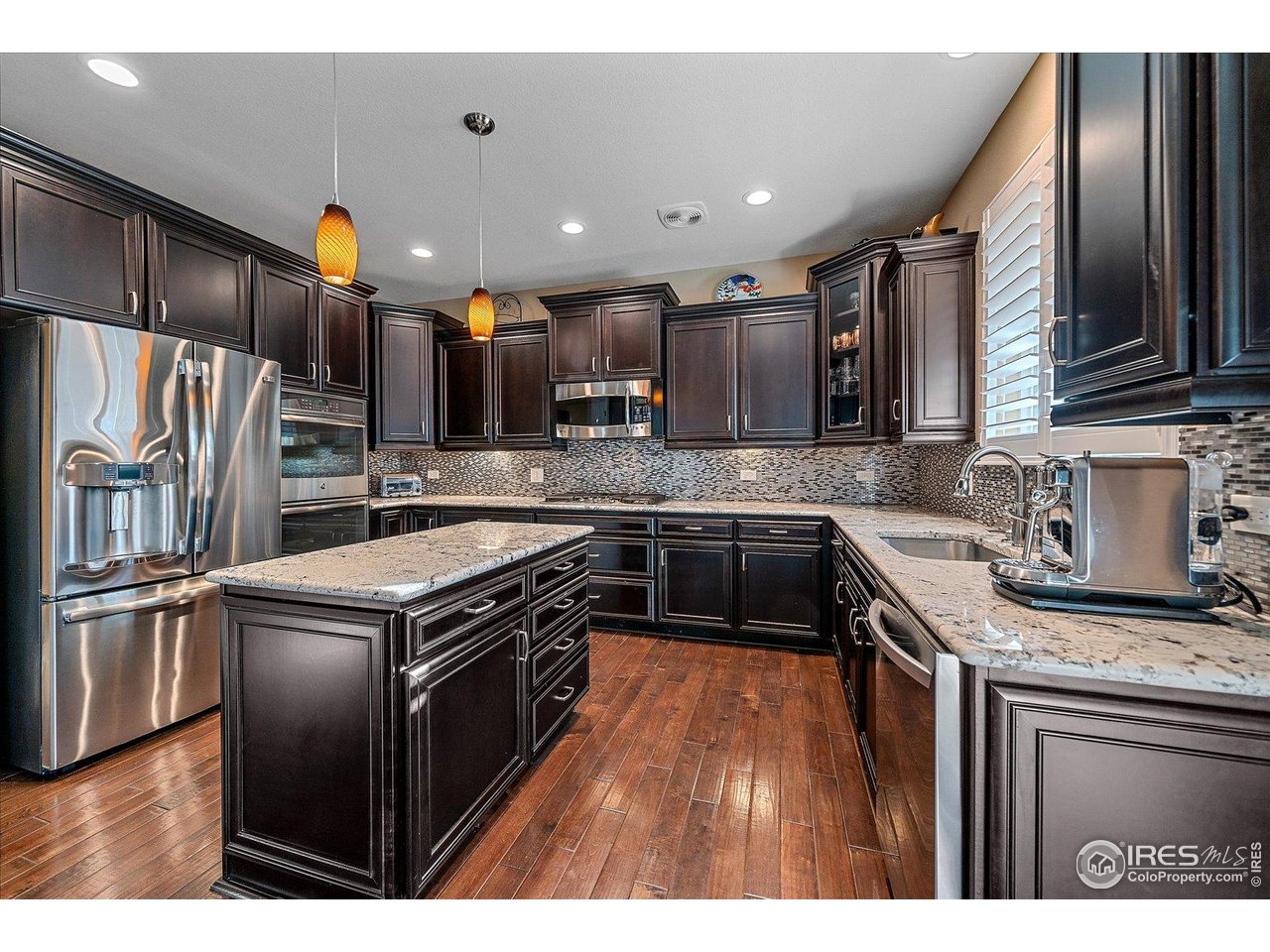 4545 South Monaco Street, Unit 324 Denver, CO 80237 - Photo 11 of 36 a kitchen with stainless steel appliances granite countertop a stove a sink dishwasher a refrigerator and a oven