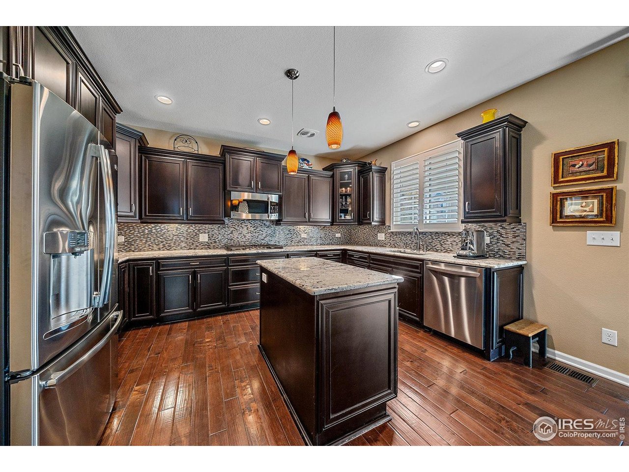 4545 South Monaco Street, Unit 324 Denver, CO 80237 - Photo 12 of 36 a kitchen with stainless steel appliances granite countertop a stove a sink and a refrigerator