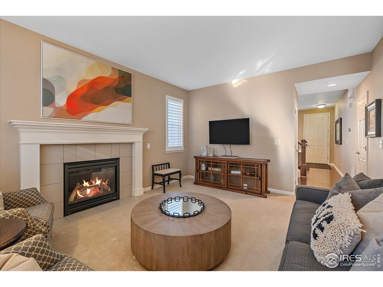4545 South Monaco Street, Unit 324 Denver, CO 80237 - Photo 14 of 36 a living room with furniture a fireplace and a flat screen tv