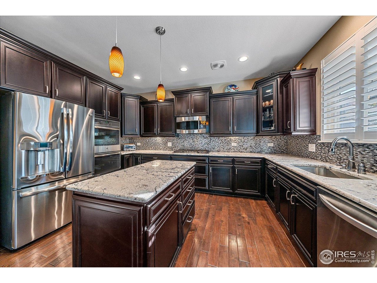 4545 South Monaco Street, Unit 324 Denver, CO 80237 - Photo 15 of 36 a kitchen with stainless steel appliances granite countertop a sink stove and refrigerator