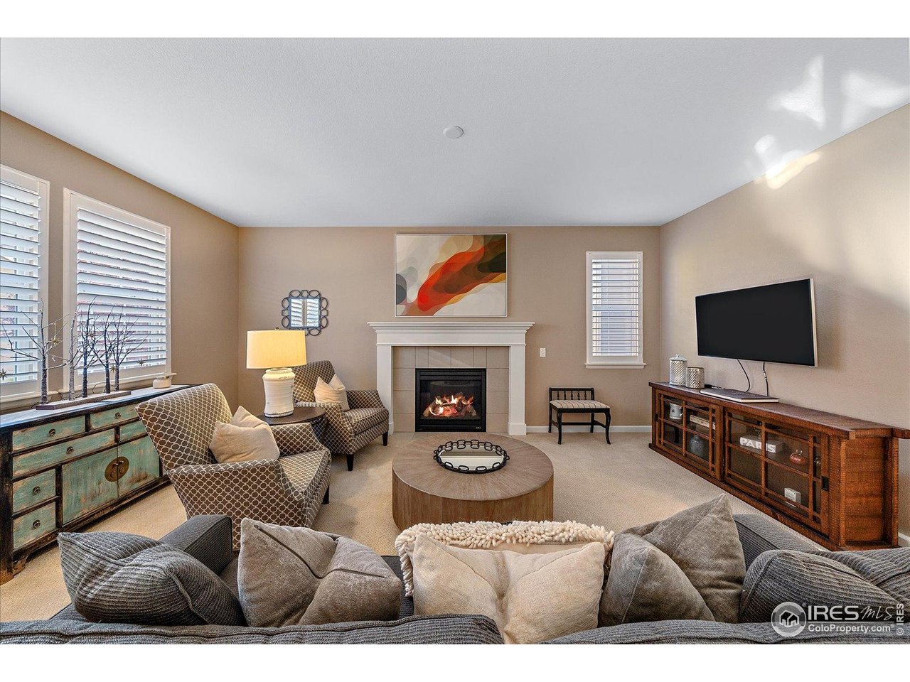 4545 South Monaco Street, Unit 324 Denver, CO 80237 - Photo 16 of 36 a living room with furniture a flat screen tv and a fireplace