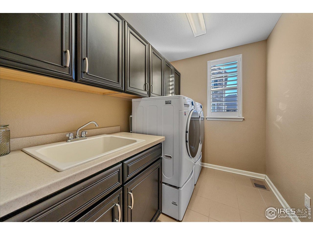 4545 South Monaco Street, Unit 324 Denver, CO 80237 - Photo 18 of 36 a bathroom with a sink and a washer dryer