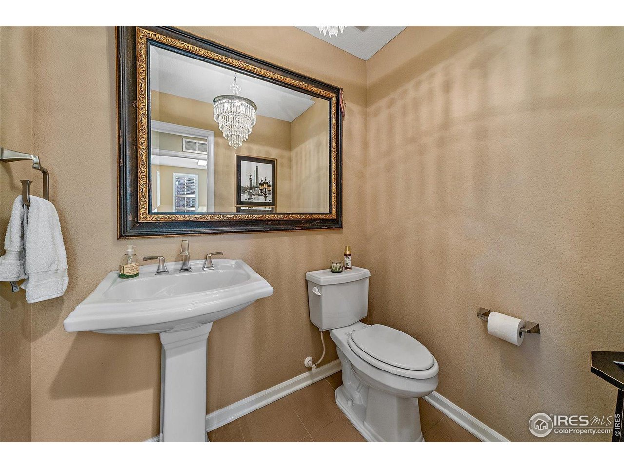 4545 South Monaco Street, Unit 324 Denver, CO 80237 - Photo 19 of 36 a bathroom with a toilet a sink and a mirror