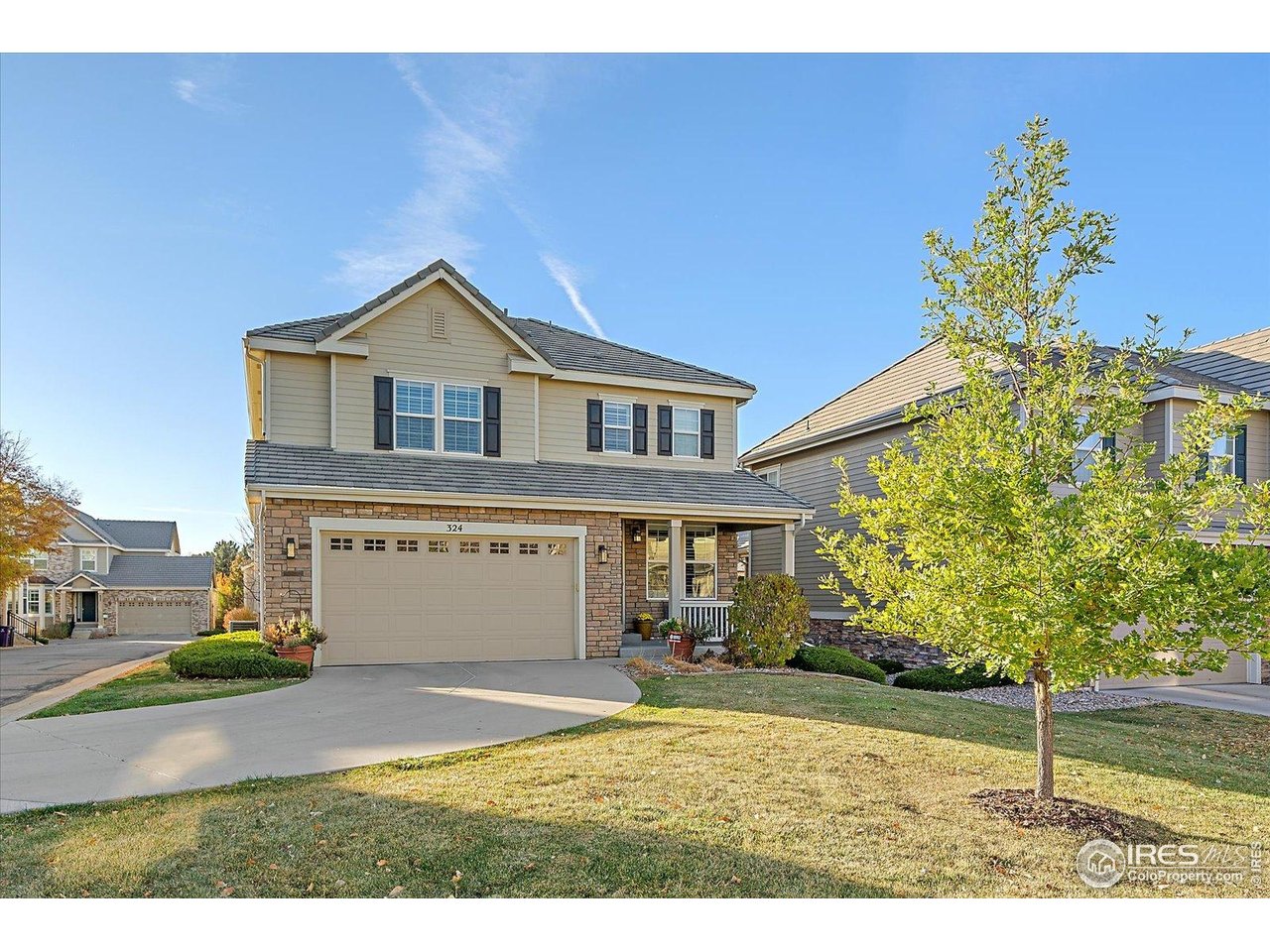 4545 South Monaco Street, Unit 324 Denver, CO 80237 - Photo 2 of 36 a front view of a house with a yard and garage