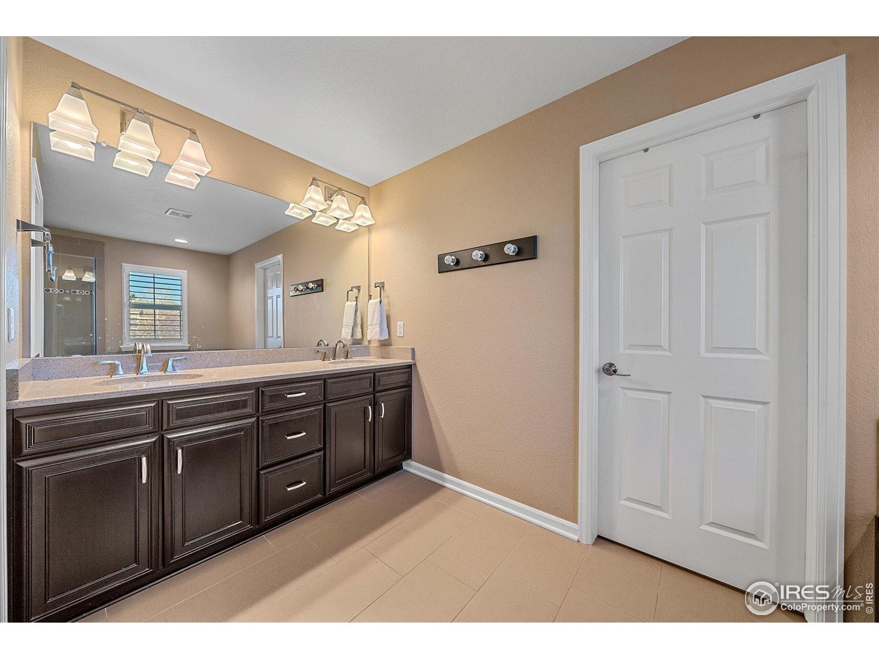 4545 South Monaco Street, Unit 324 Denver, CO 80237 - Photo 23 of 36 a spacious bathroom with a double vanity sink and a mirror