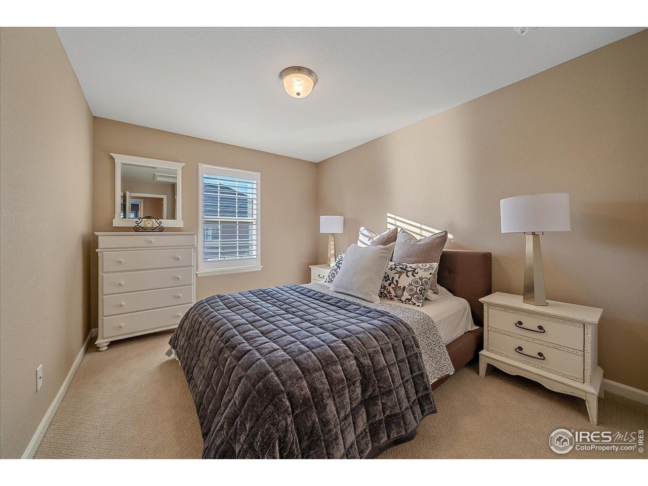 4545 South Monaco Street, Unit 324 Denver, CO 80237 - Photo 27 of 36 a bedroom with a bed and a night stand