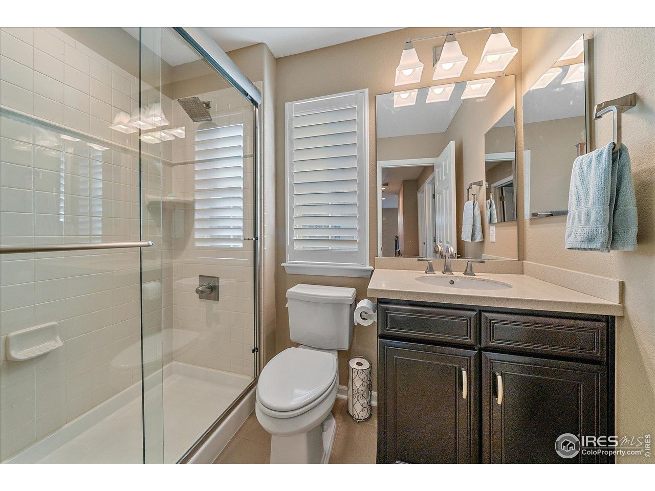 4545 South Monaco Street, Unit 324 Denver, CO 80237 - Photo 28 of 36 a bathroom with a sink a toilet a mirror and shower