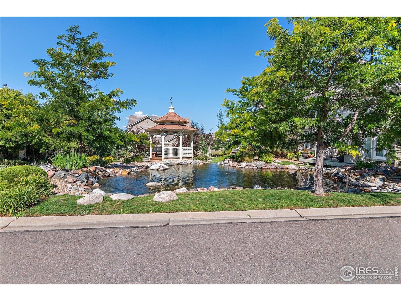 4545 South Monaco Street, Unit 324 Denver, CO 80237 - Photo 33 of 36 a front view of a house with a yard