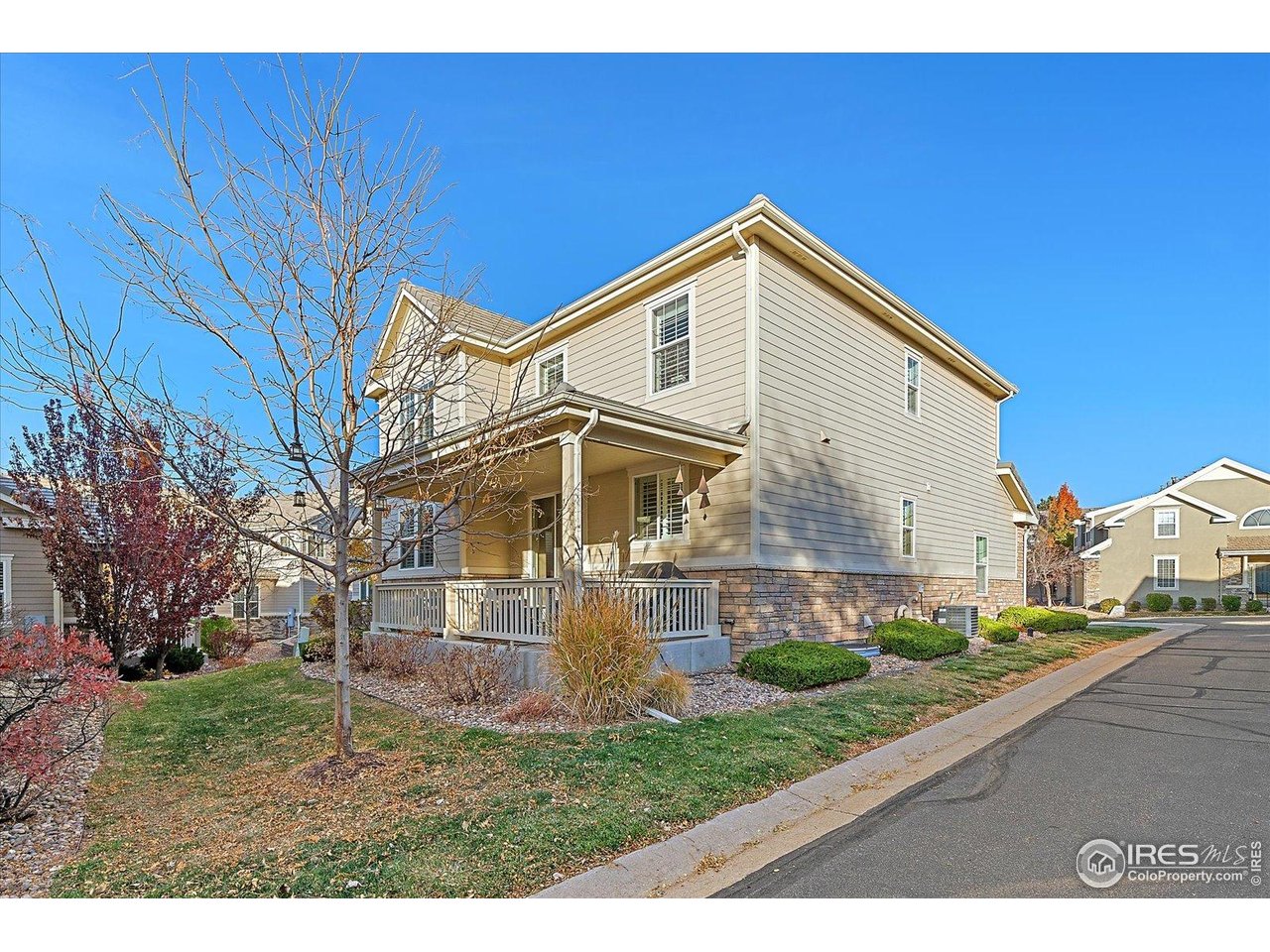 4545 South Monaco Street, Unit 324 Denver, CO 80237 - Photo 34 of 36 a view of a white house with a big yard and large trees