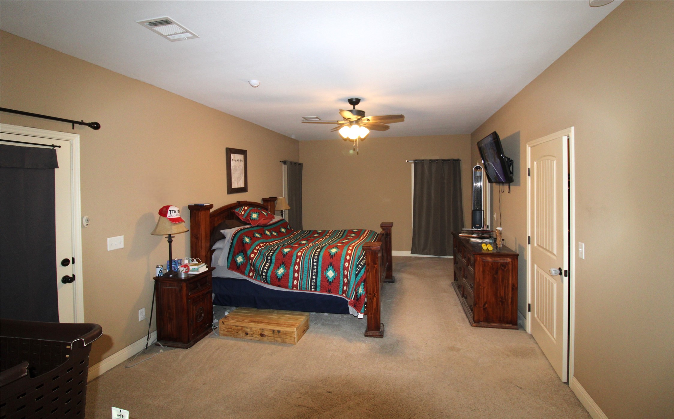 14620 Lyric Road Conroe, TX 77302 - Photo 17 of 43 a bedroom with bed and a chandelier