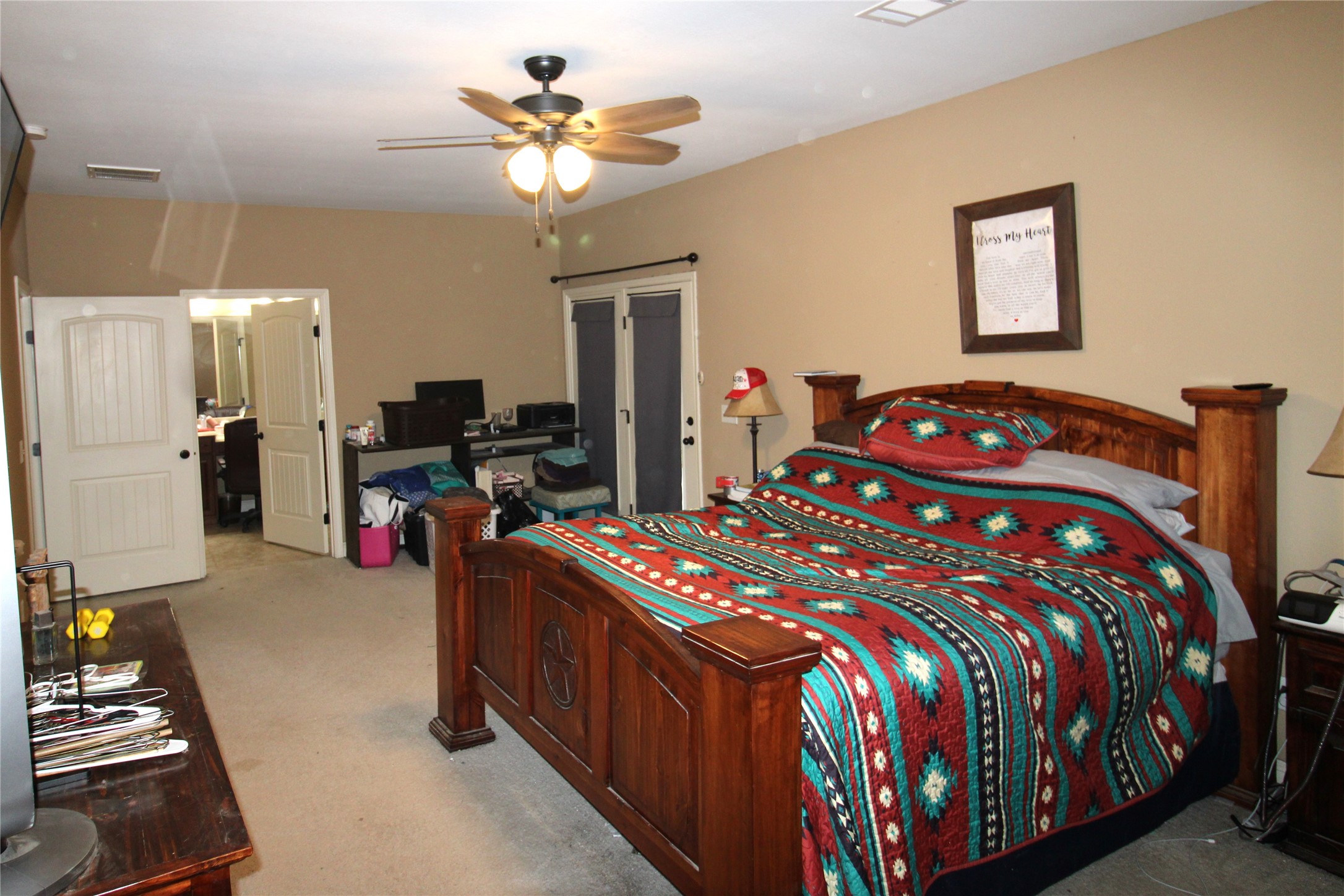 14620 Lyric Road Conroe, TX 77302 - Photo 18 of 43 a bedroom with a bed and a chandelier