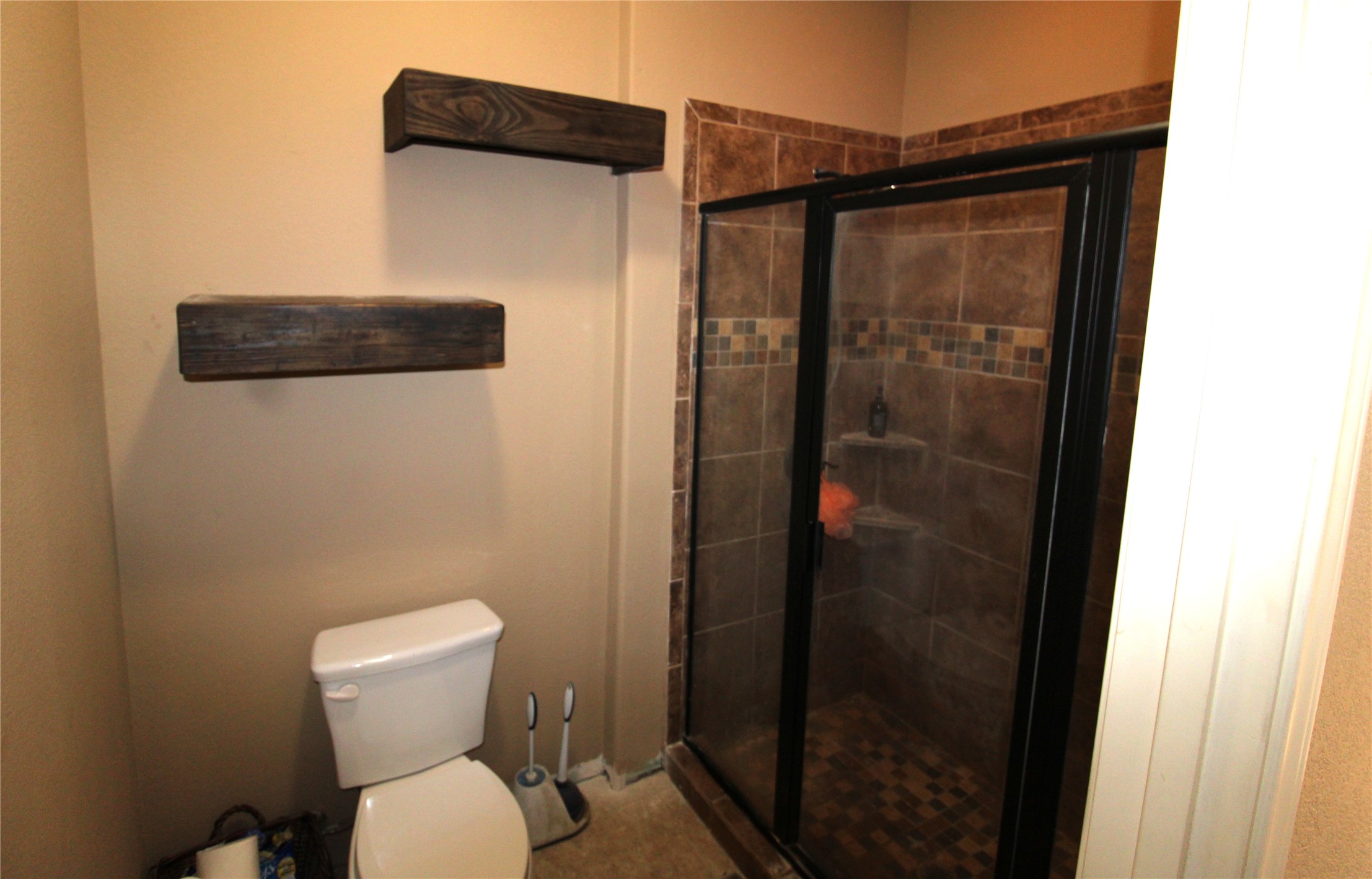 14620 Lyric Road Conroe, TX 77302 - Photo 23 of 43 a bathroom with a toilet and a shower