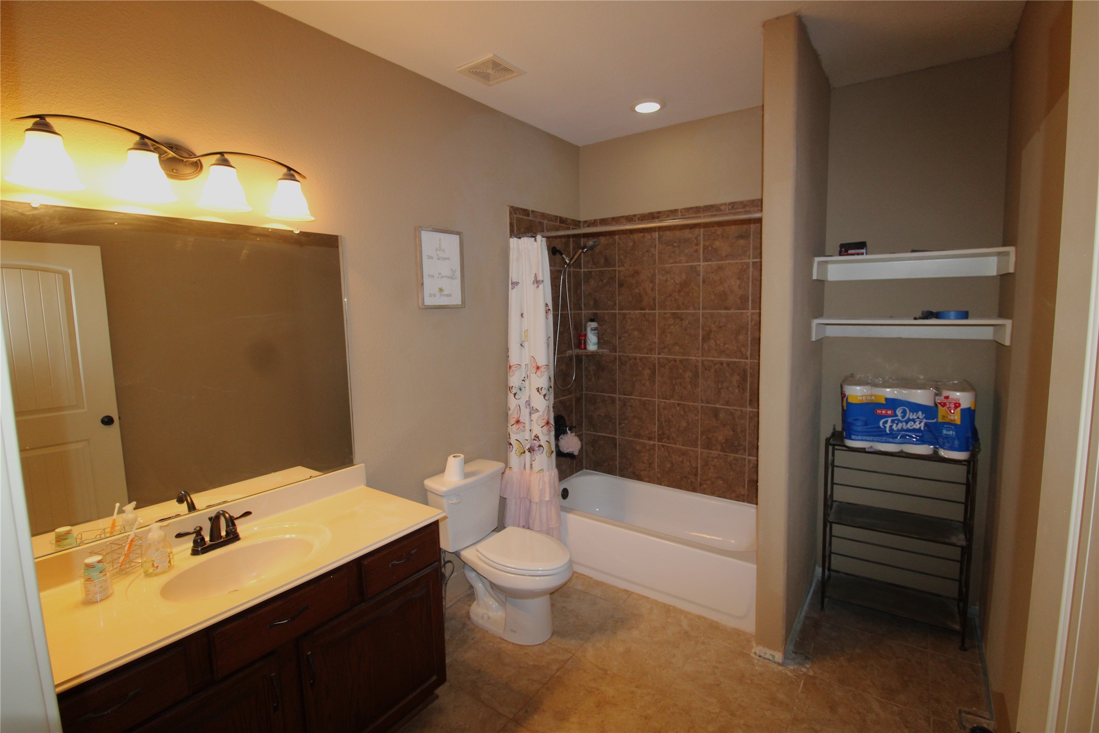 14620 Lyric Road Conroe, TX 77302 - Photo 25 of 43 a bathroom with a sink a toilet and shower