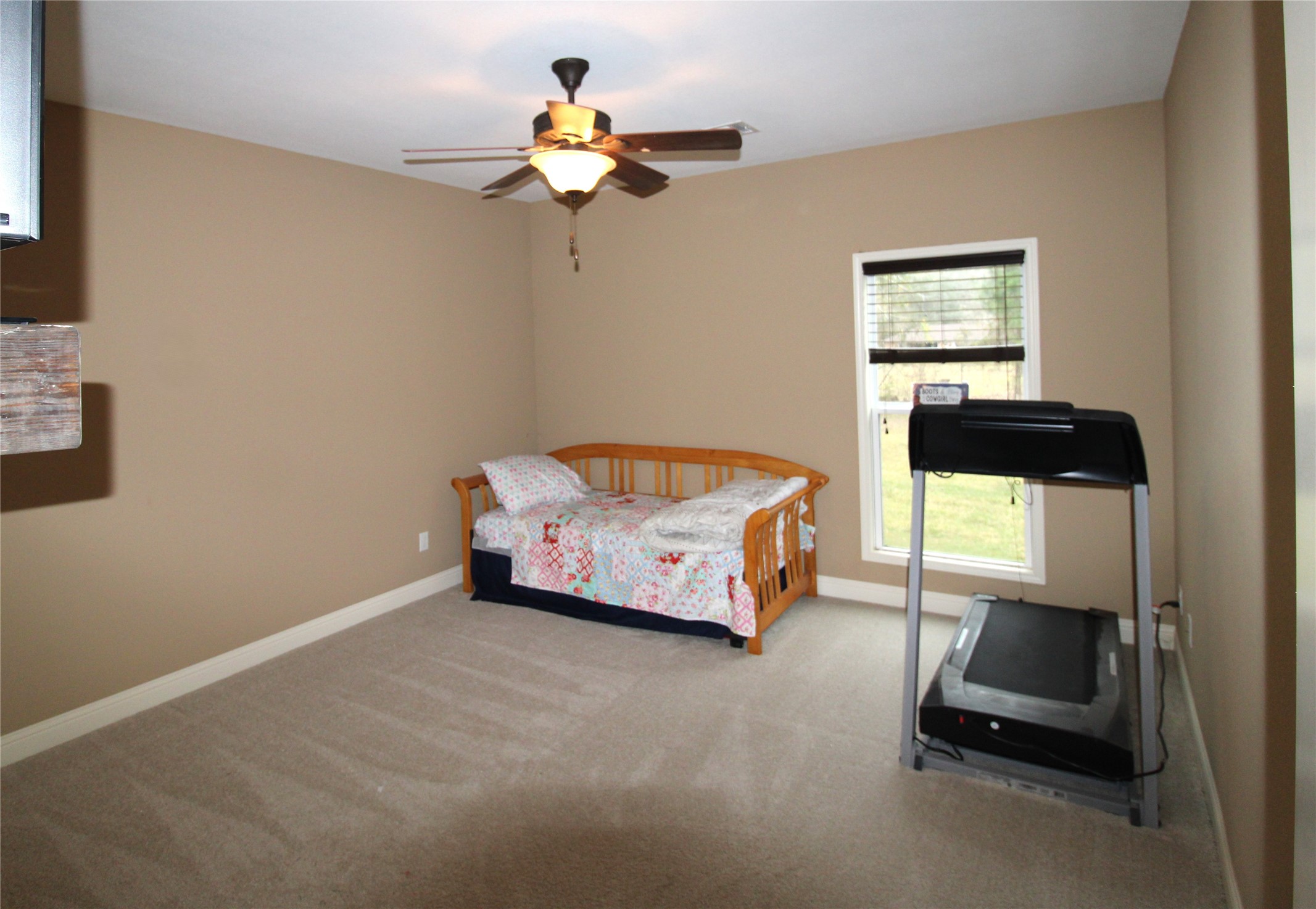 14620 Lyric Road Conroe, TX 77302 - Photo 26 of 43 a bedroom with a bed and a chandelier