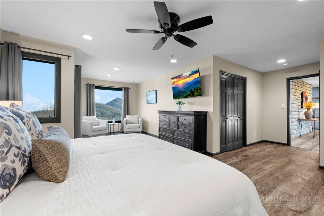 351 Windy Knob Trail Seven Devils, NC 28604 - Photo 22 of 50 a spacious bedroom with a bed and a flat screen tv