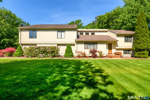 a view of an house with backyard space and balcony