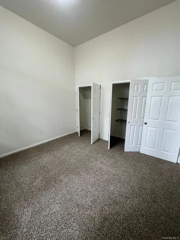 a view of an empty room and closet area