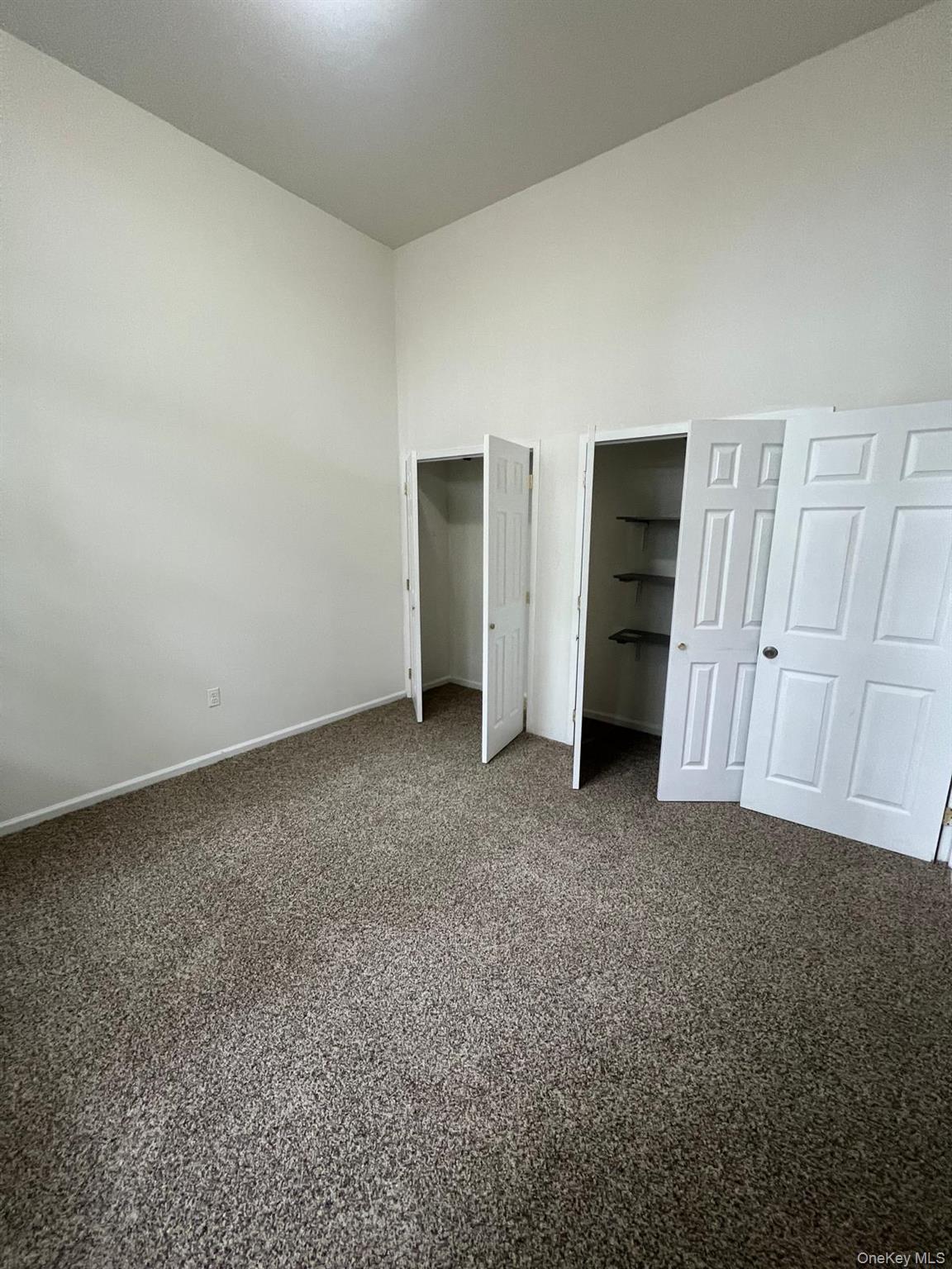 a view of an empty room and closet area
