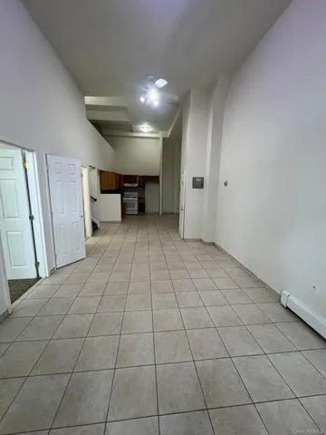 a living room with stainless steel appliances furniture a counter top space