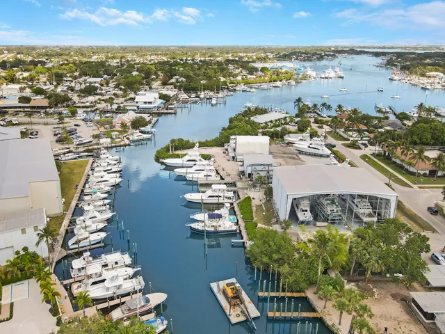 an aerial view of ocean and residential houses with outdoor space