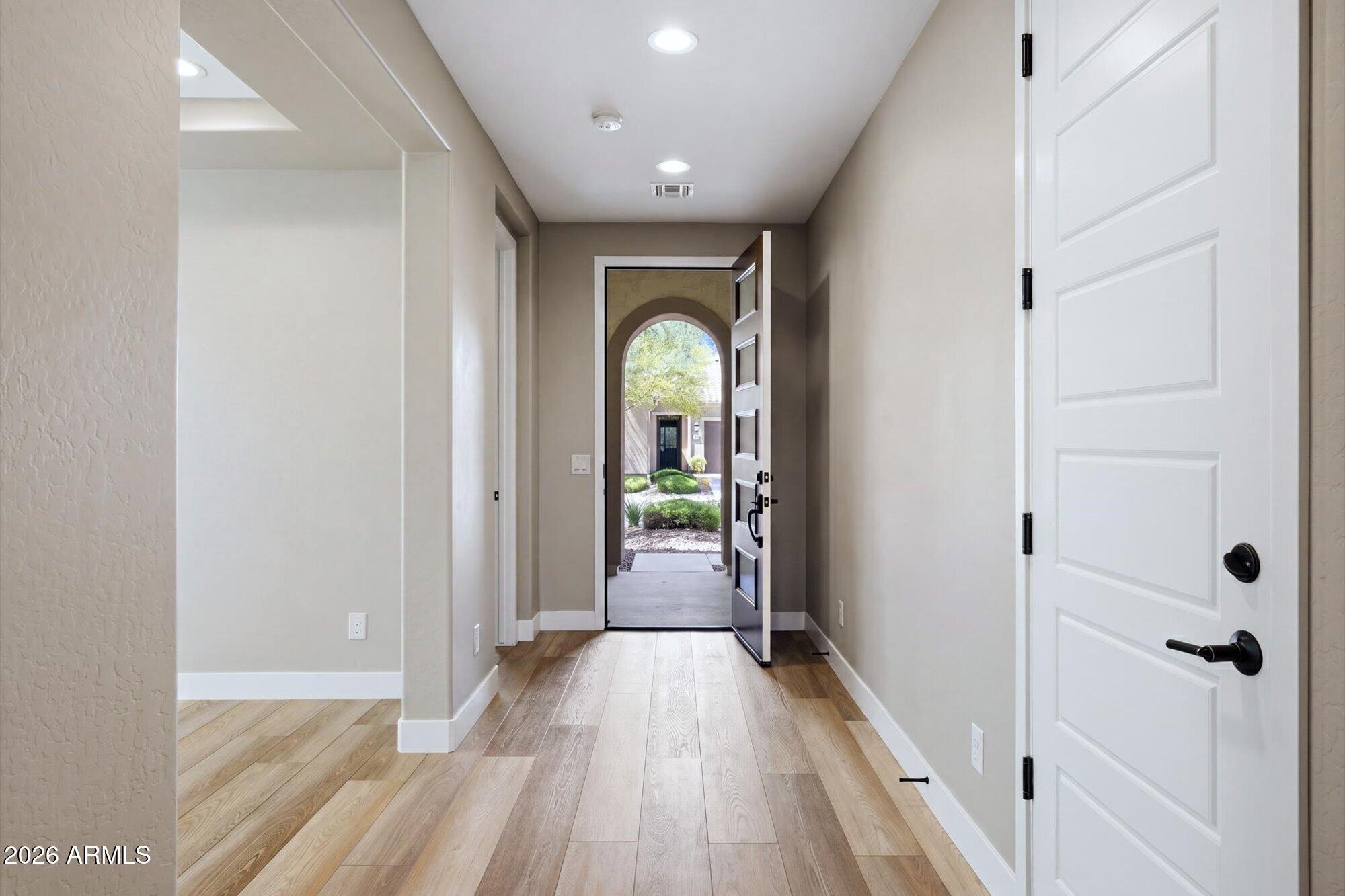 16849 West Merrell Street Goodyear, AZ 85395 - Photo 3 of 35 a view of a hallway view with wooden floor and staircase