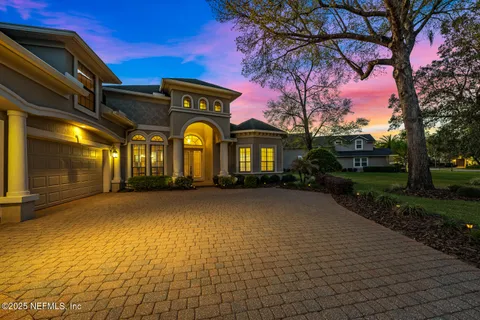 a view of a brick house with many windows