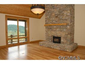 145 Fieldstone Road Clyde, NC 28721 - Photo 11 of 24 a view of empty room with wooden floor and fan
