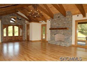 145 Fieldstone Road Clyde, NC 28721 - Photo 12 of 24 a view of an empty room with a window and wooden floor