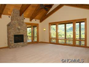 145 Fieldstone Road Clyde, NC 28721 - Photo 14 of 24 a view of an empty room with a fireplace and a window