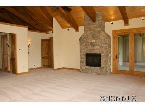 145 Fieldstone Road Clyde, NC 28721 - Photo 15 of 24 a view of an empty room with a fireplace