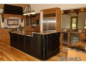 145 Fieldstone Road Clyde, NC 28721 - Photo 5 of 24 a kitchen with stainless steel appliances kitchen island granite countertop a sink and cabinets