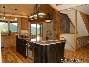 145 Fieldstone Road Clyde, NC 28721 - Photo 8 of 24 a kitchen with stainless steel appliances granite countertop a sink a stove and a wooden floors