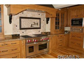 145 Fieldstone Road Clyde, NC 28721 - Photo 9 of 24 a kitchen with stainless steel appliances granite countertop a stove and a microwave