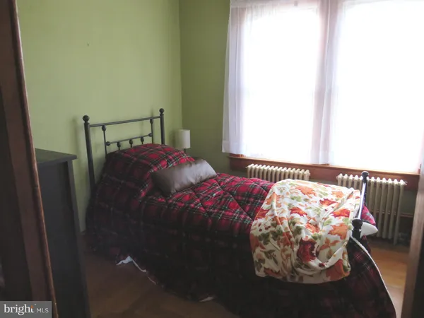 a bed sitting in a bedroom next to a window