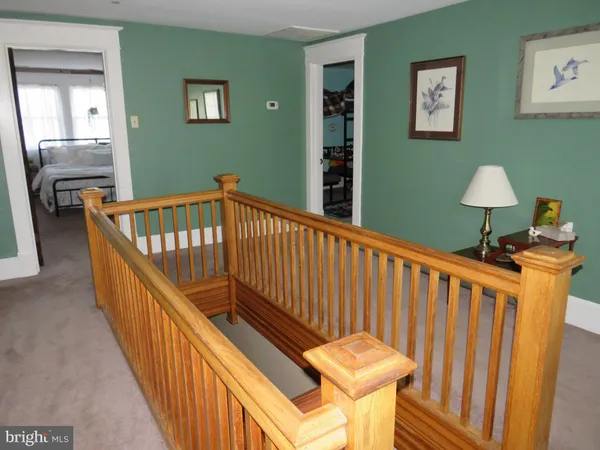 a view of staircase with furniture and a window