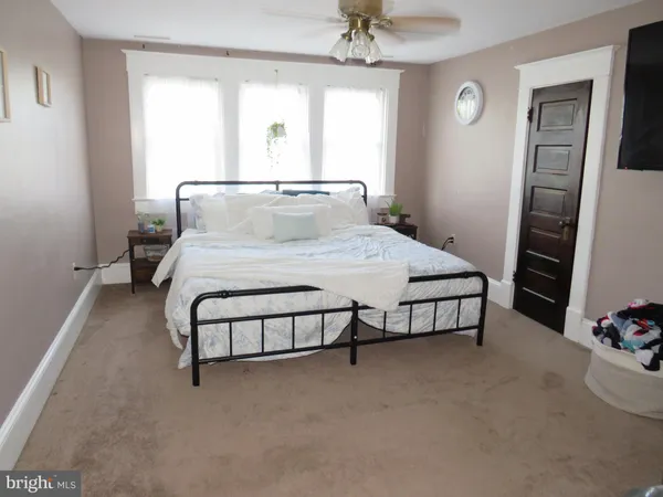 a bedroom with a bed and a dresser
