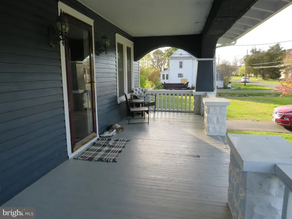 a view of a porch with a table and chairs